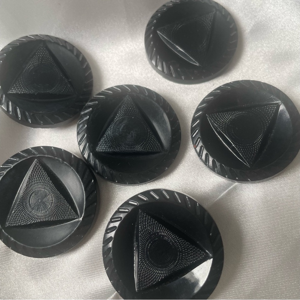 Vintage Black buttons.Approximately 1.5 in diameter. Triangular design in center
